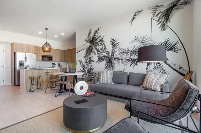 a living room with furniture and a chandelier