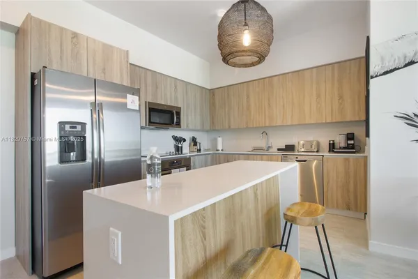 a kitchen with a sink appliances and cabinets