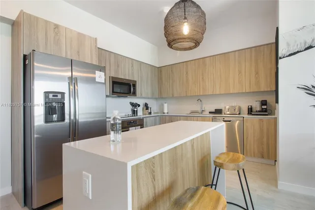 a kitchen with a sink appliances and cabinets