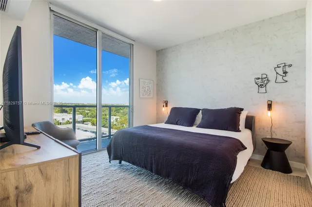 a bedroom with a bed and large window