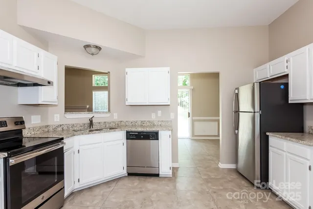 a kitchen with a sink stove and refrigerator