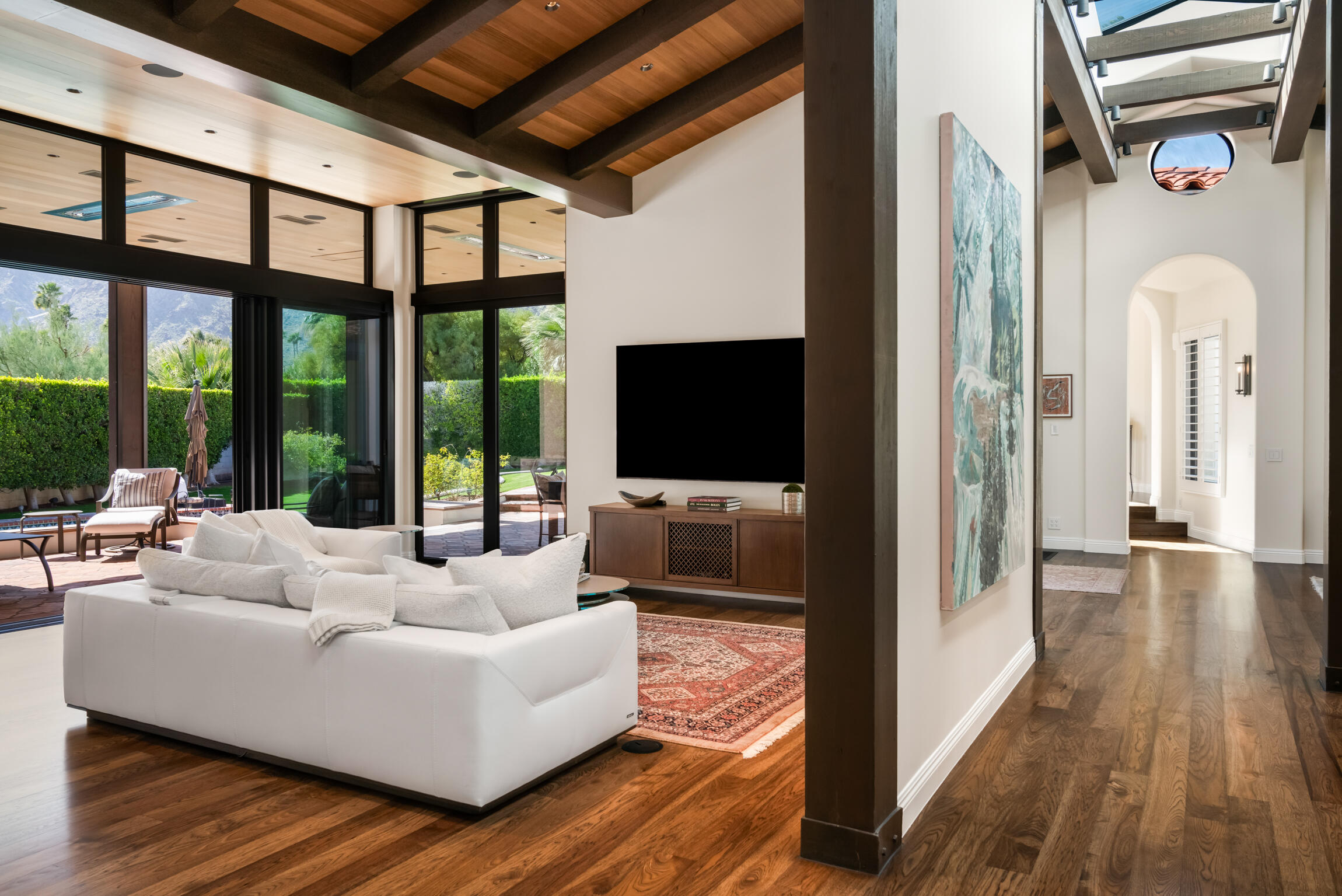 555 West Stevens Road Palm Springs, CA 92262 - Photo 22 of 95 a living room with furniture tv and a floor to ceiling window