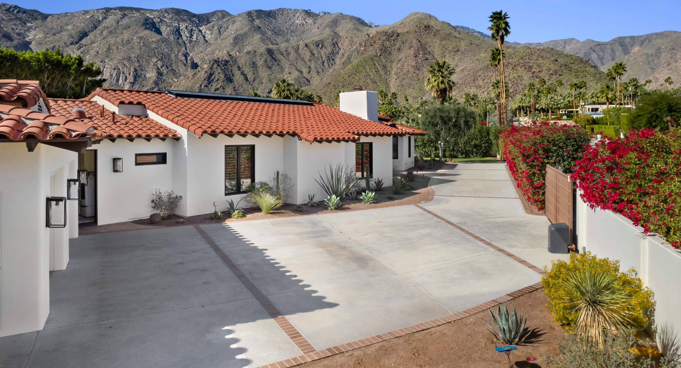 555 West Stevens Road Palm Springs, CA 92262 - Photo 94 of 95 a view of a white house with a yard and potted plants