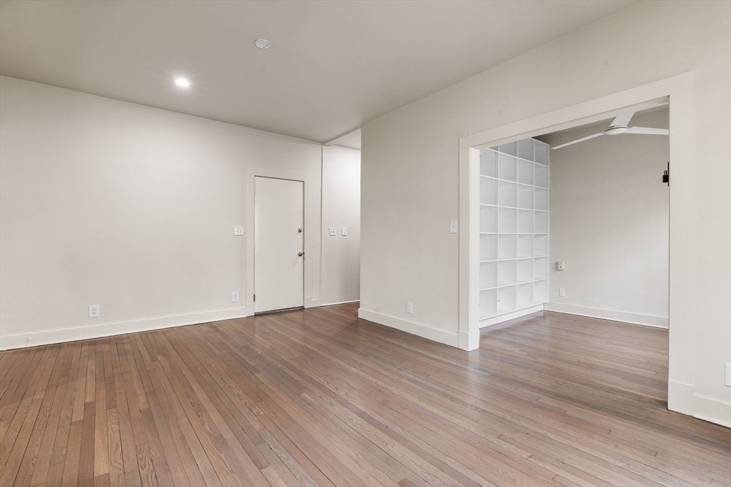 74 Fenway, Unit 45 Boston, MA 02115 - Photo 5 of 11 a view of an empty room with wooden floor and closet