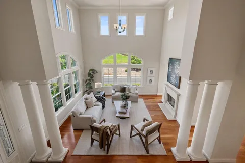 a living room with furniture a rug and white walls