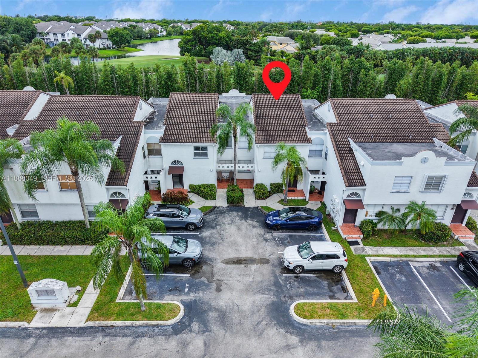 an aerial view of a house with garden space table and chairs