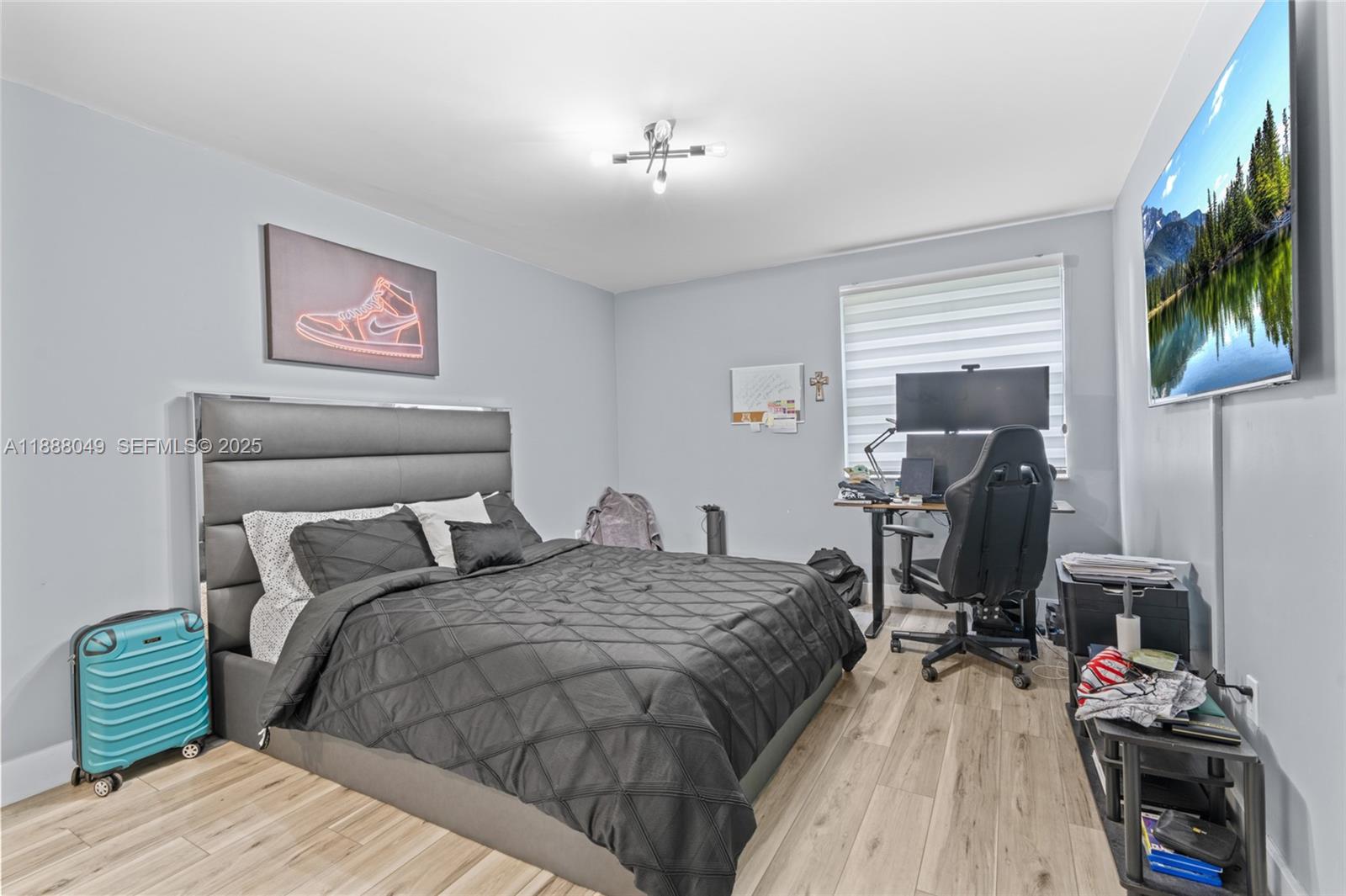 4624 Northwest 97th Place, Unit 252 Doral, FL 33178 - Photo 16 of 28 a bedroom with a bed and a flat screen tv