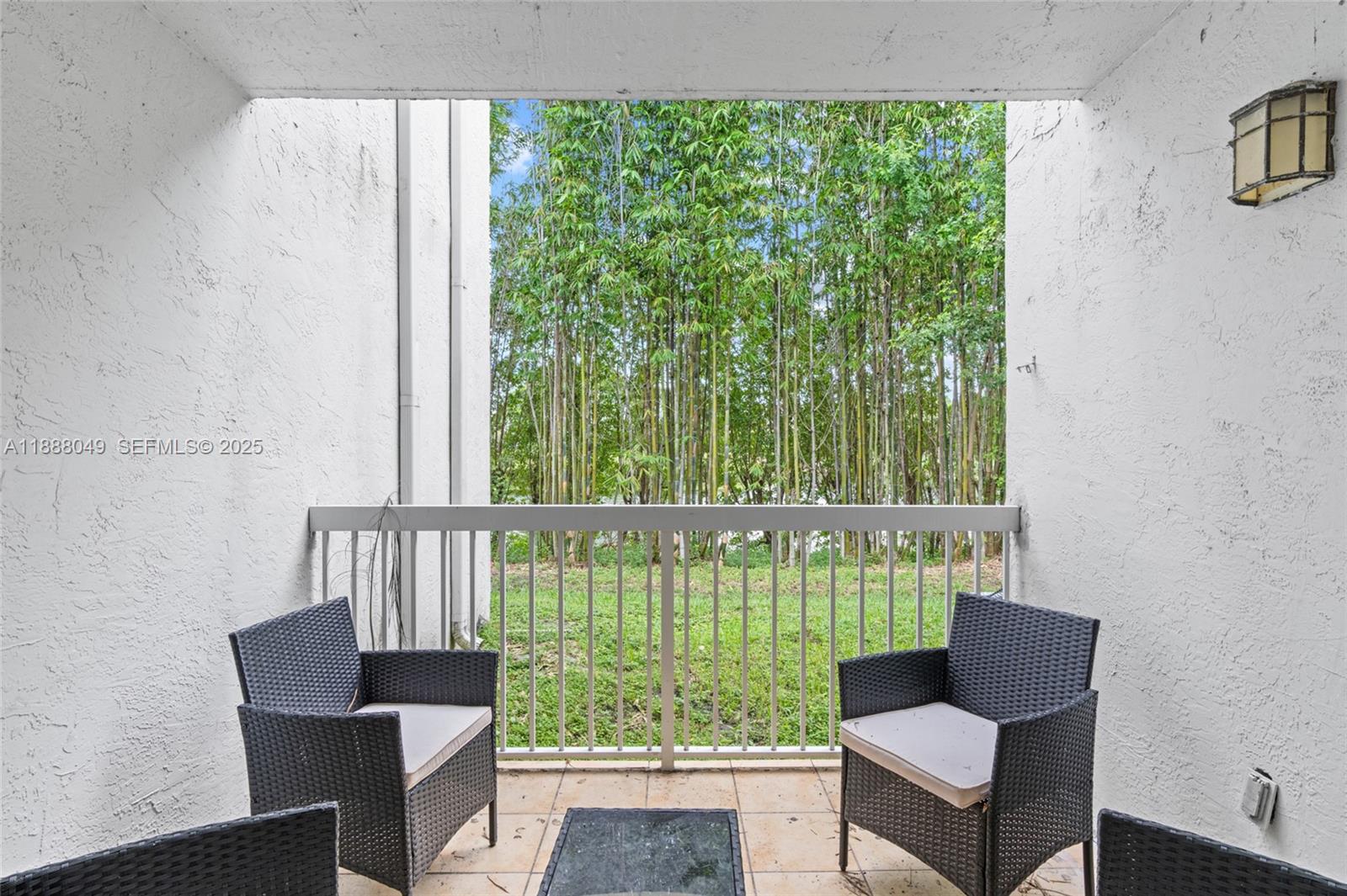 4624 Northwest 97th Place, Unit 252 Doral, FL 33178 - Photo 19 of 28 a view of a chair and table in the balcony