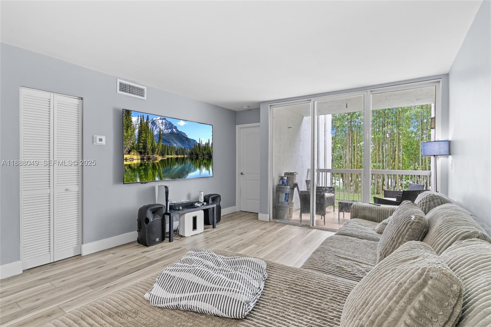 4624 Northwest 97th Place, Unit 252 Doral, FL 33178 - Photo 9 of 28 a bedroom with a bed a flat screen tv and a large window