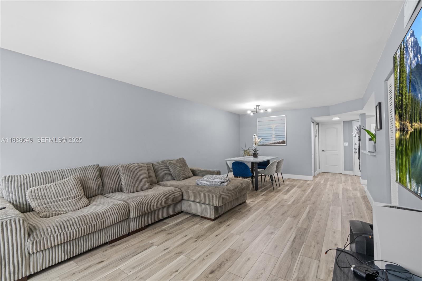 4624 Northwest 97th Place, Unit 252 Doral, FL 33178 - Photo 10 of 28 a living room with furniture and a wooden floor