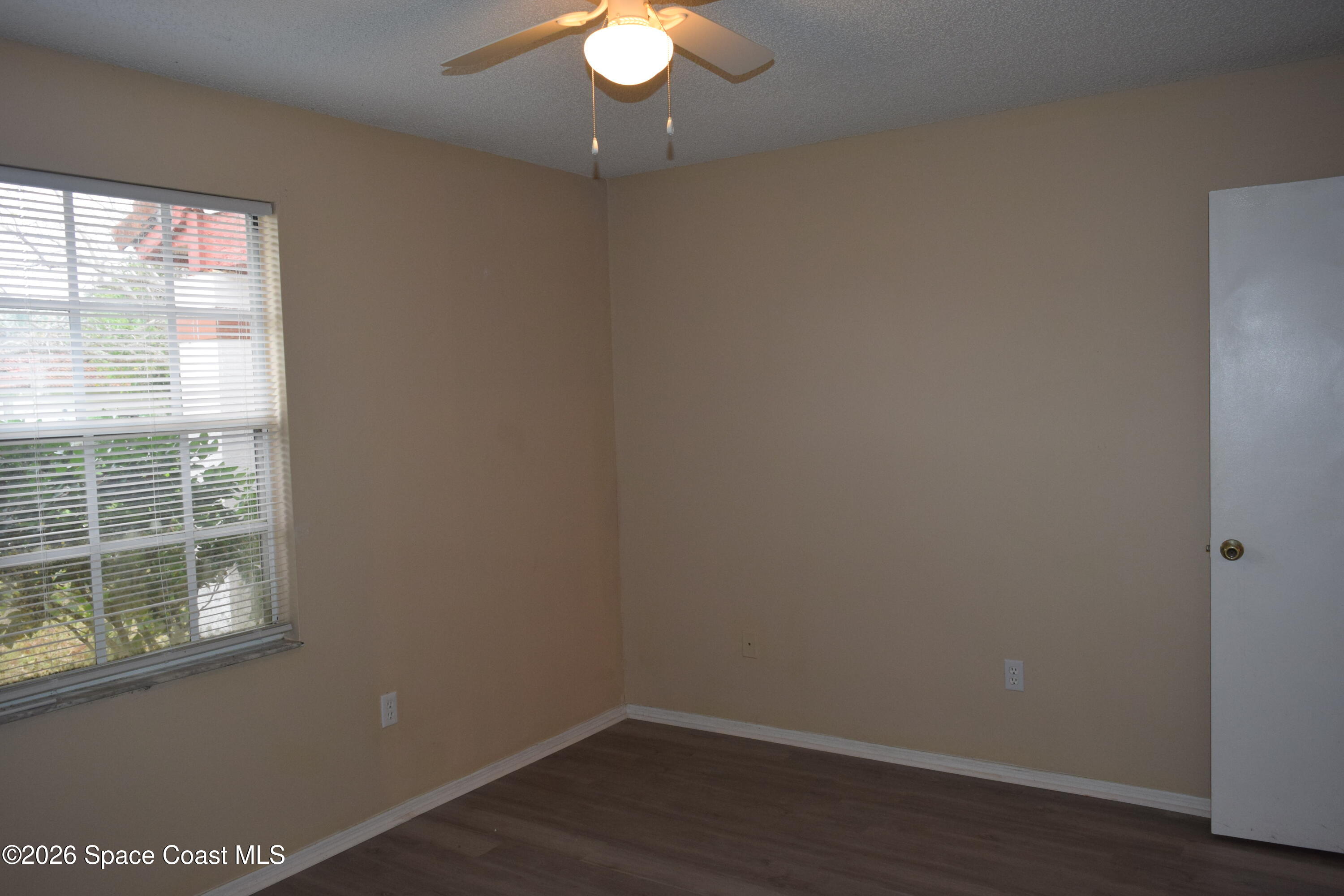 213 Abello Road Southeast Palm Bay, FL 32909 - Photo 17 of 23 a view of empty room with wooden floor and fan