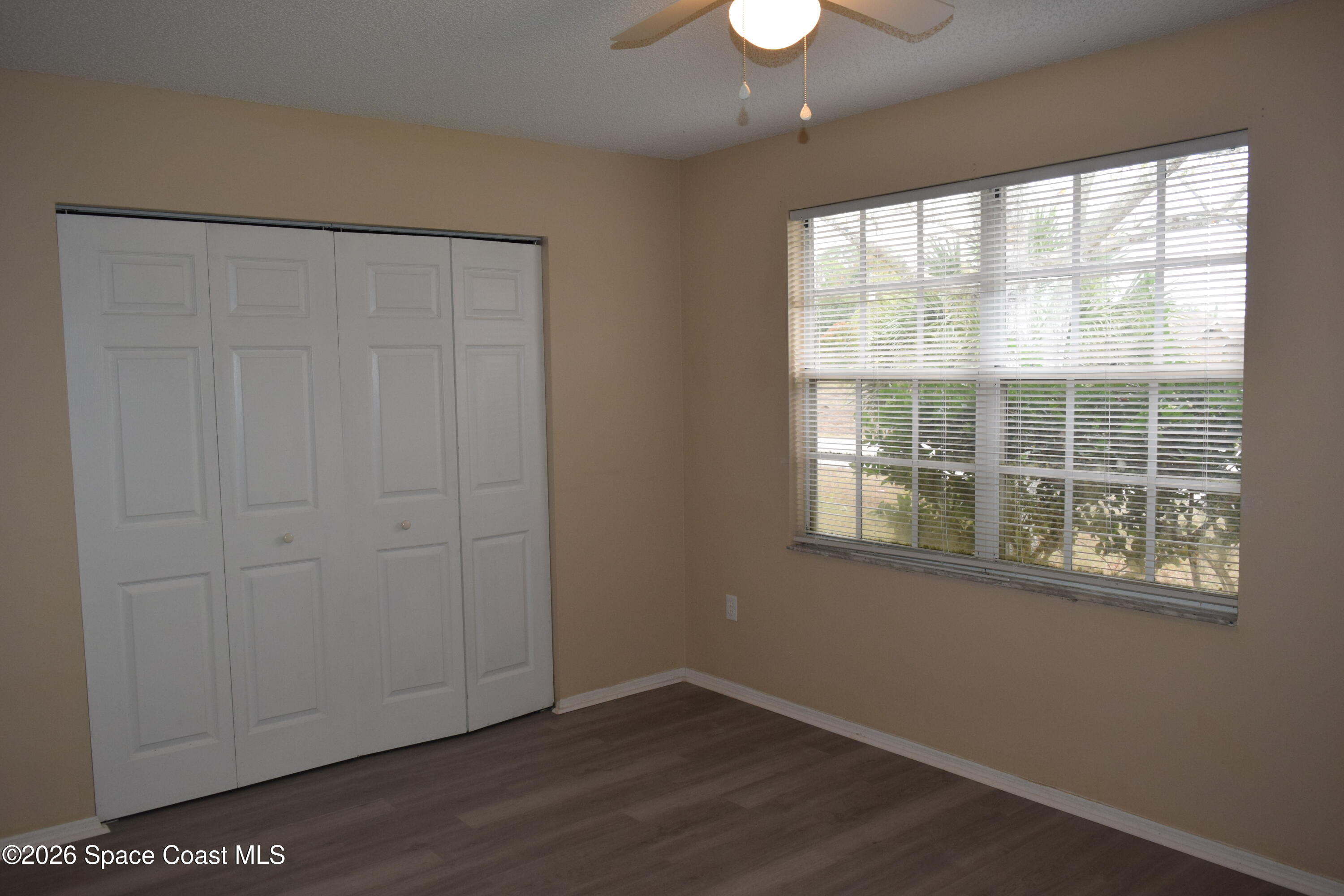 213 Abello Road Southeast Palm Bay, FL 32909 - Photo 18 of 23 an empty room with wooden floor and windows
