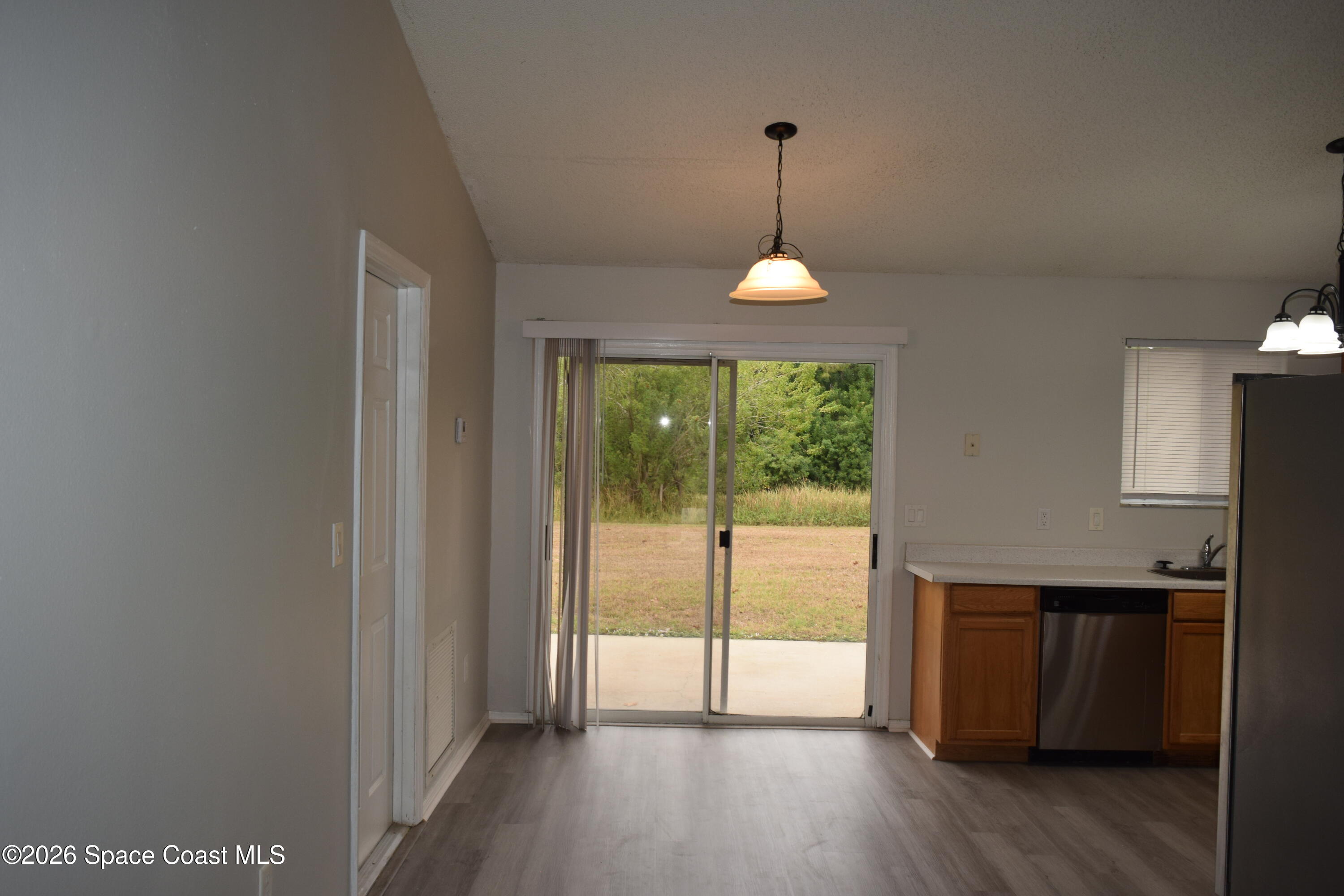 213 Abello Road Southeast Palm Bay, FL 32909 - Photo 6 of 23 a view of empty room with wooden floor and fan