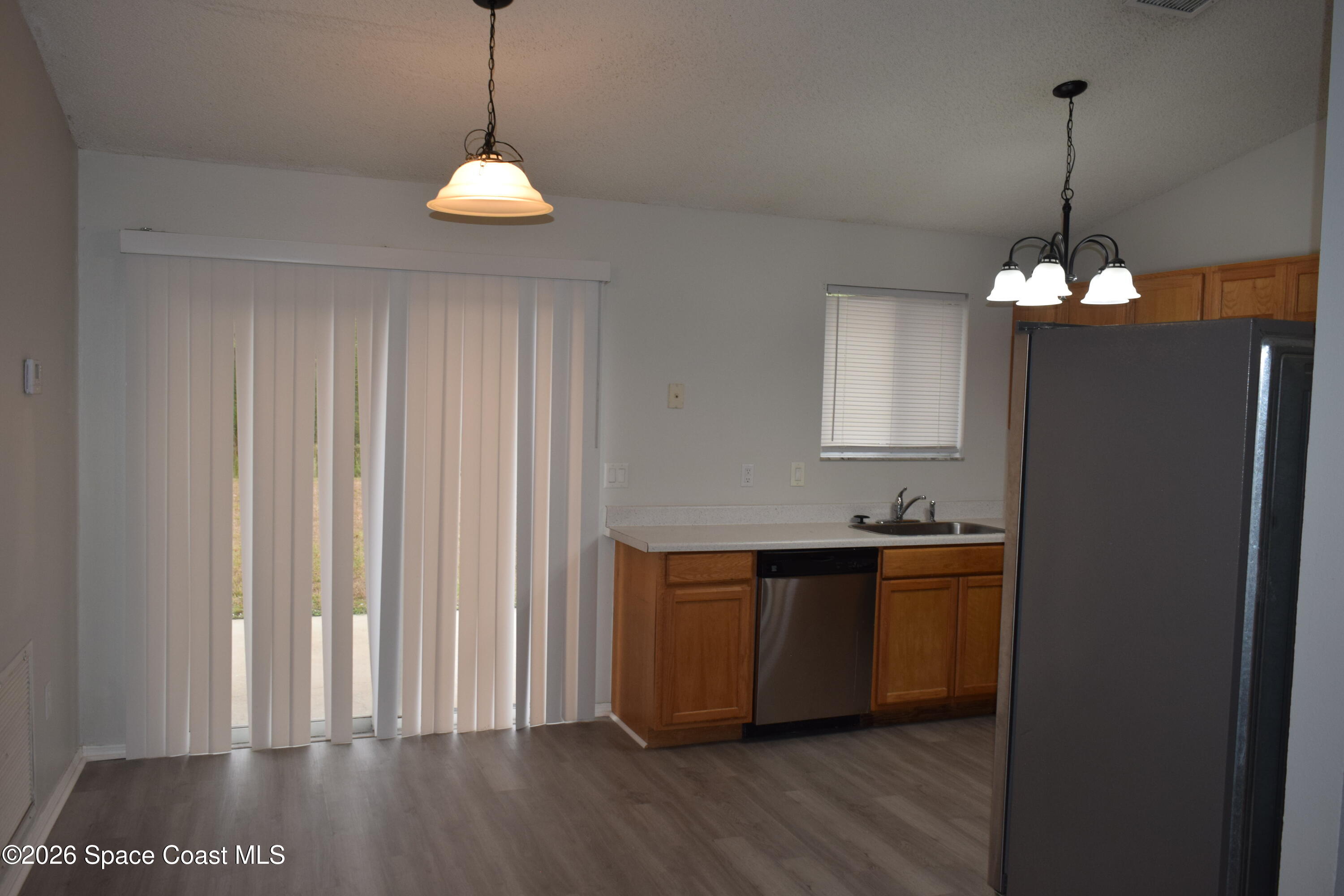 213 Abello Road Southeast Palm Bay, FL 32909 - Photo 8 of 23 a view of a room with wooden floor and windows