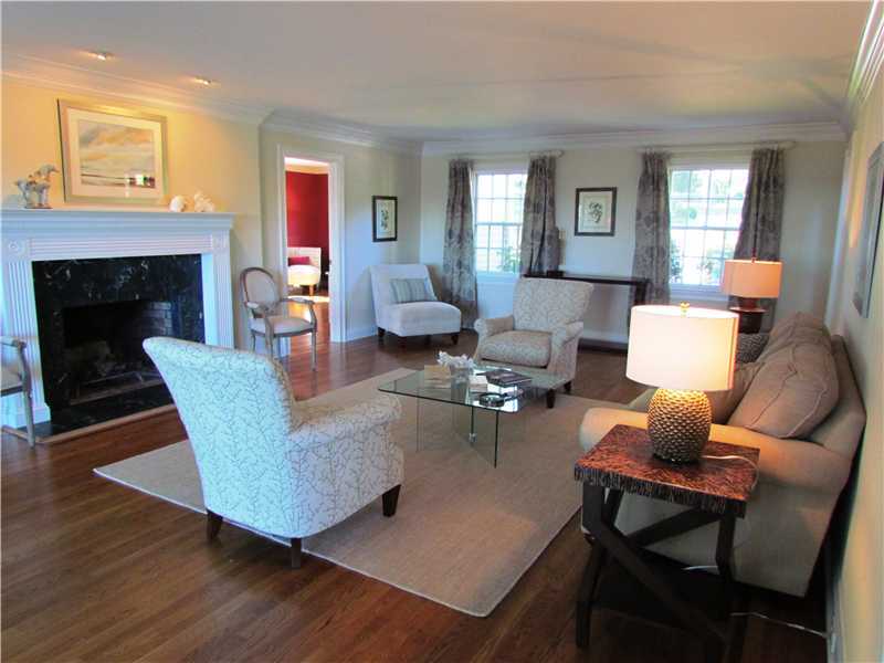 115 Long Neck Point Road Darien, CT 06820 - Photo 4 of 21 a living room with furniture wooden floor and a fireplace