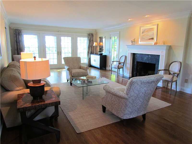 115 Long Neck Point Road Darien, CT 06820 - Photo 5 of 21 a living room with furniture fireplace and dining table