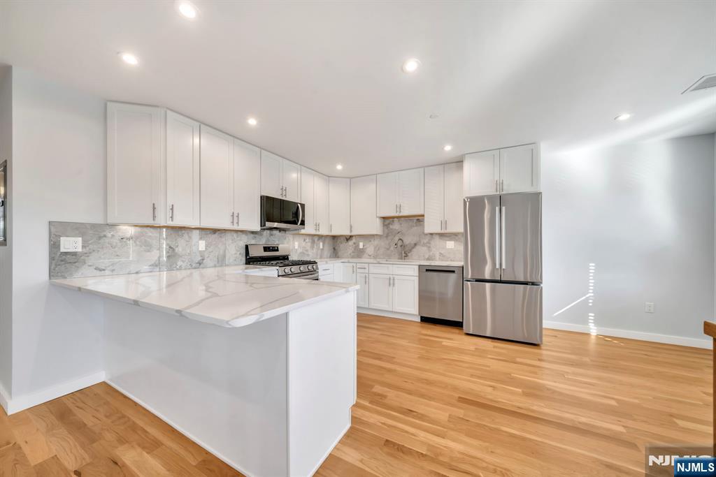 615 Schuyler Avenue, Unit B Lyndhurst, NJ 07071 - Photo 3 of 9 a kitchen with stainless steel appliances a refrigerator sink and microwave