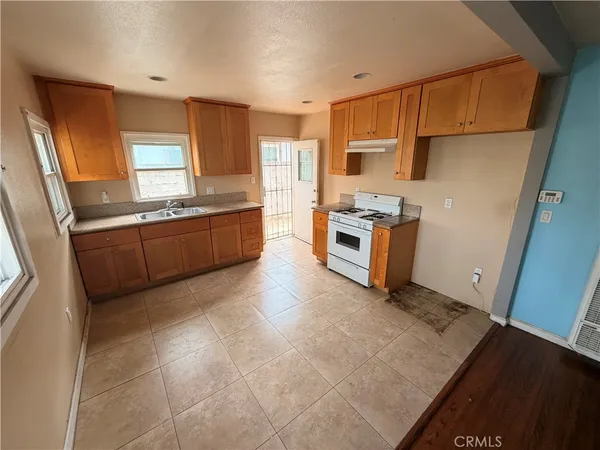 a kitchen with stainless steel appliances granite countertop a stove refrigerator sink and dishwasher