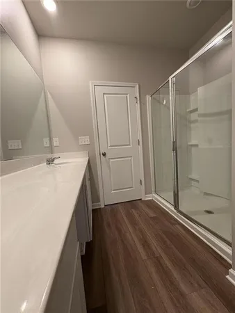 a bathroom with a sink a mirror and shower