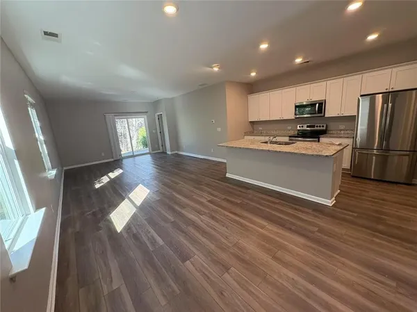 a view of kitchen with sink microwave and refrigerator