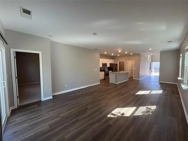a view of a kitchen with a sink and a living room