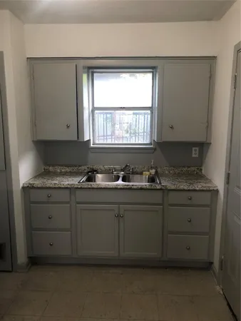 a bathroom with a granite countertop sink and a vanity