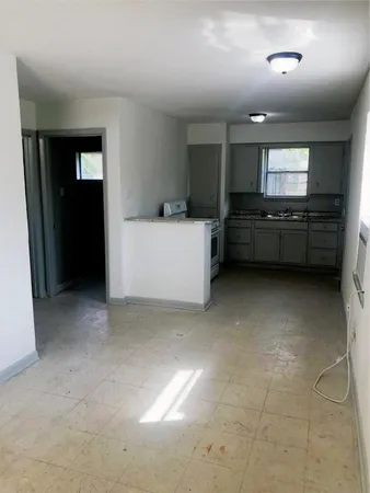 a view of room with kitchen