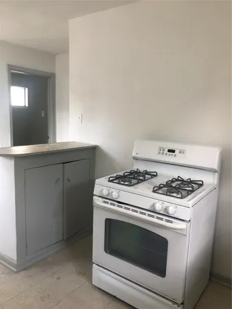 a stove top oven sitting inside of a kitchen