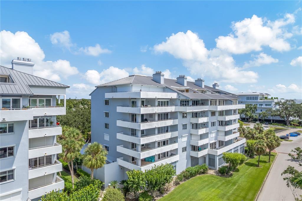 1000 Riverside Drive, Unit B504 Palmetto, FL 34221 - Photo 17 of 48 a view of a building with many windows and a yard