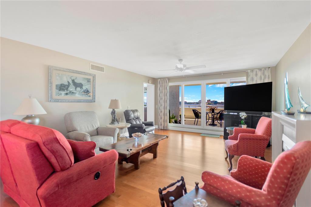 1000 Riverside Drive, Unit B504 Palmetto, FL 34221 - Photo 29 of 48 a living room with furniture a flat screen tv and a fireplace