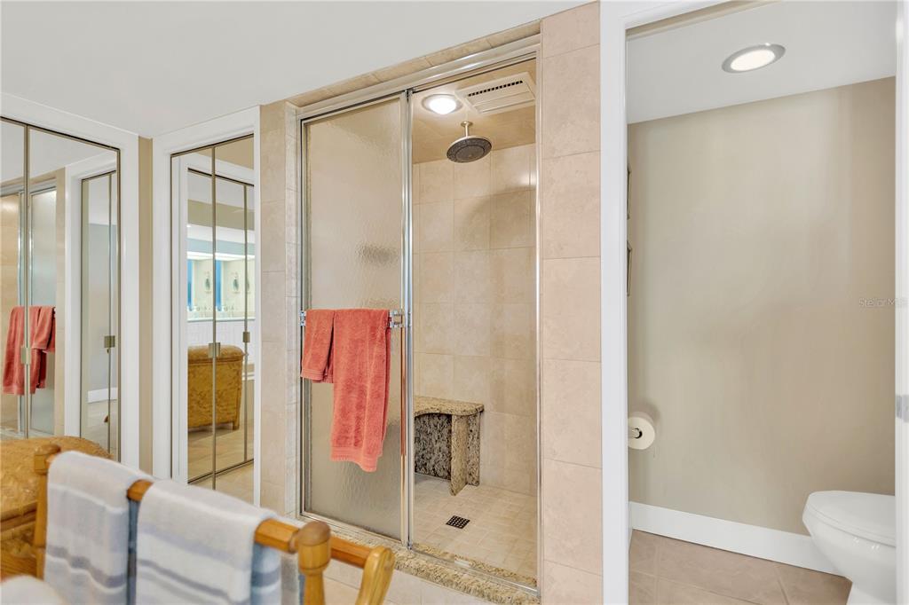 1000 Riverside Drive, Unit B504 Palmetto, FL 34221 - Photo 35 of 48 a bathroom with a glass shower door and a mirror