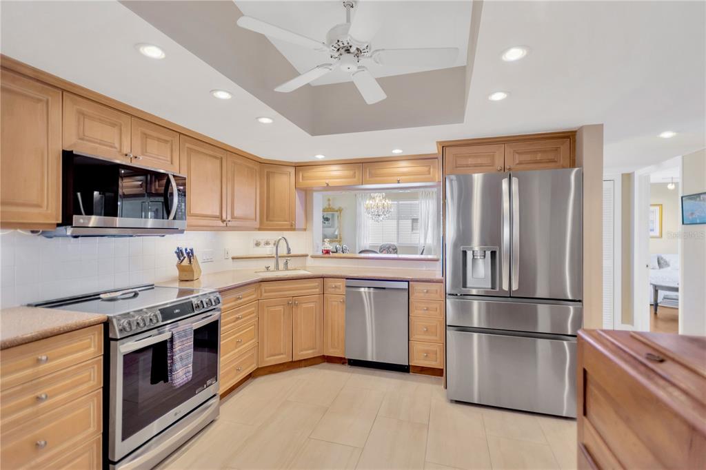 1000 Riverside Drive, Unit B504 Palmetto, FL 34221 - Photo 38 of 48 a kitchen with stainless steel appliances granite countertop a refrigerator a stove a sink and a microwave