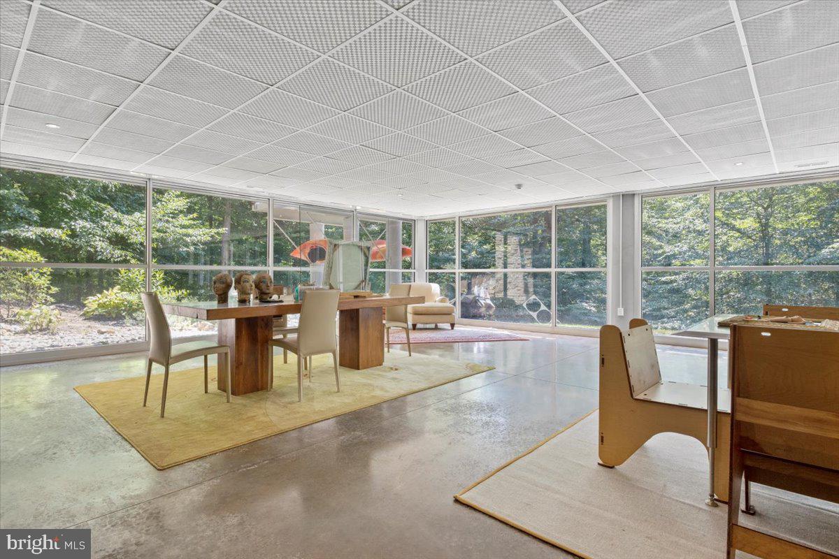 5553 Beverleys Mill Road Broad Run, VA 20137 - Photo 46 of 80 a dining room with furniture and a floor to ceiling window