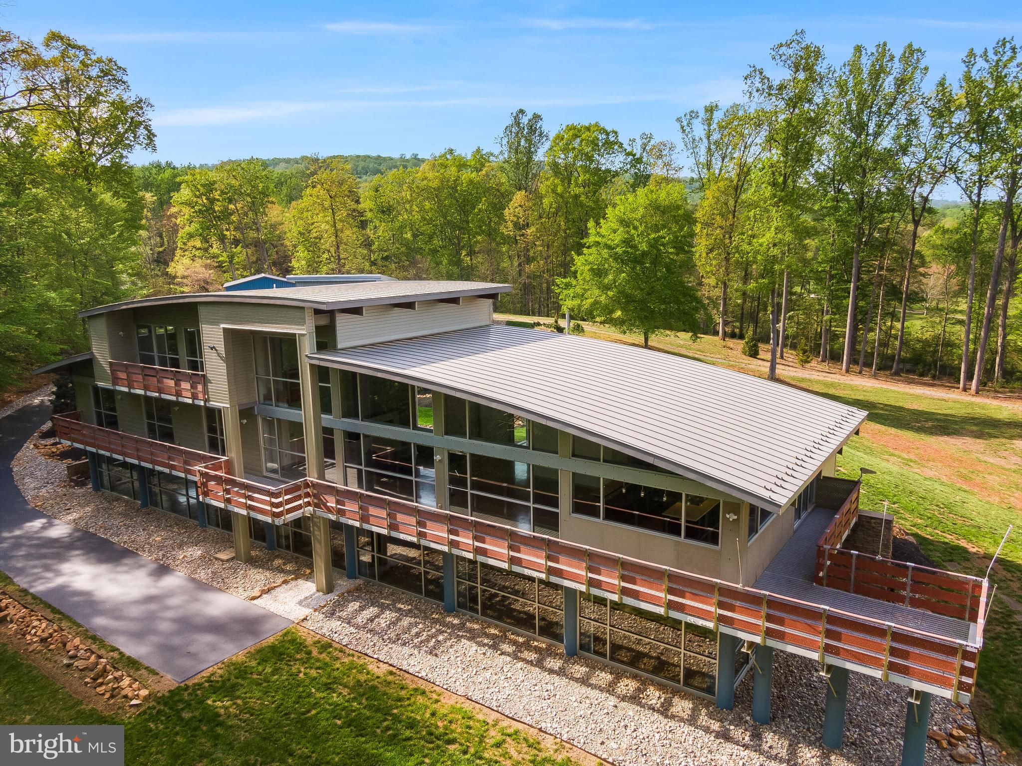 5553 Beverleys Mill Road Broad Run, VA 20137 - Photo 51 of 80 a view of a house with a large window and a yard with wooden fence
