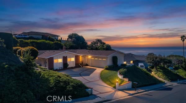 3512 Heroic Drive Rancho Palos Verdes, CA 90275 - Photo 1 of 1 a front view of a house with a yard table and chairs with wooden fence