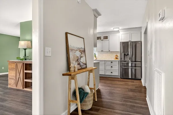 a kitchen with a sink a potted plant and cabinets