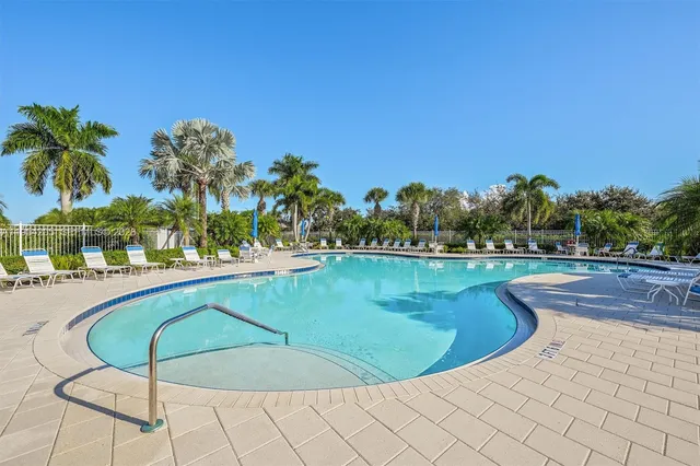 a swimming pool with outdoor seating and yard