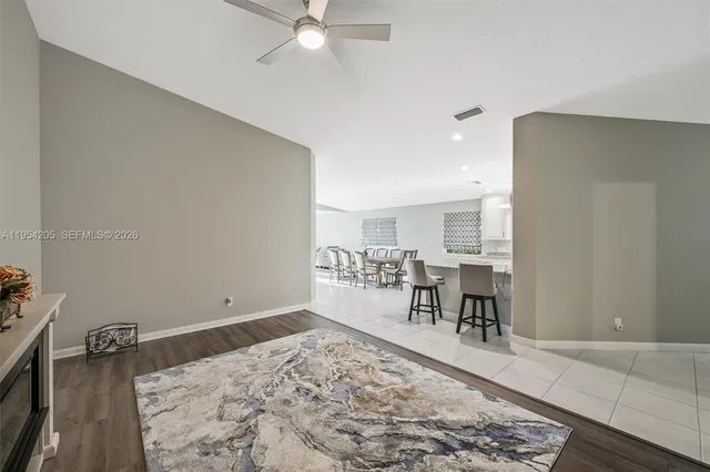 a living room with furniture and a dining table
