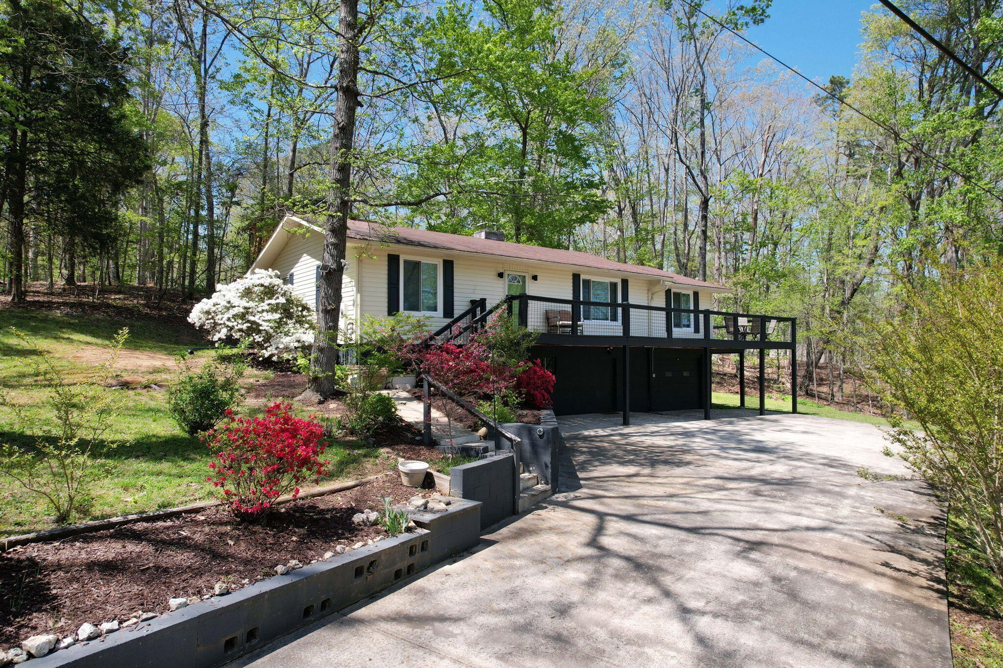 a front view of a house with a yard and a garden