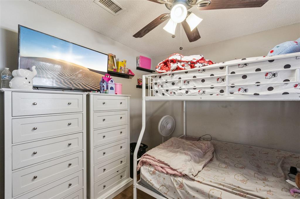 4608 Frisco Circle Orlando, FL 32808 - Photo 14 of 26 a bed room with a bed and a dresser