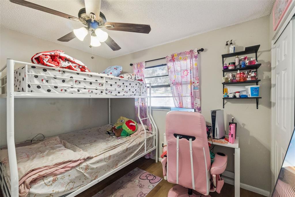 4608 Frisco Circle Orlando, FL 32808 - Photo 15 of 26 a bed room with a bed and a book shelf