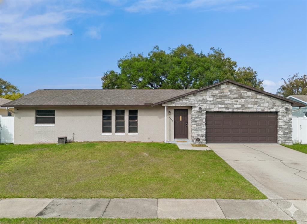 4608 Frisco Circle Orlando, FL 32808 - Photo 2 of 26 a house that has a tree in front of it