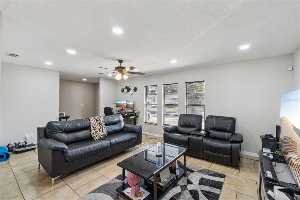 4608 Frisco Circle Orlando, FL 32808 - Photo 6 of 26 a living room with furniture and a wooden floor