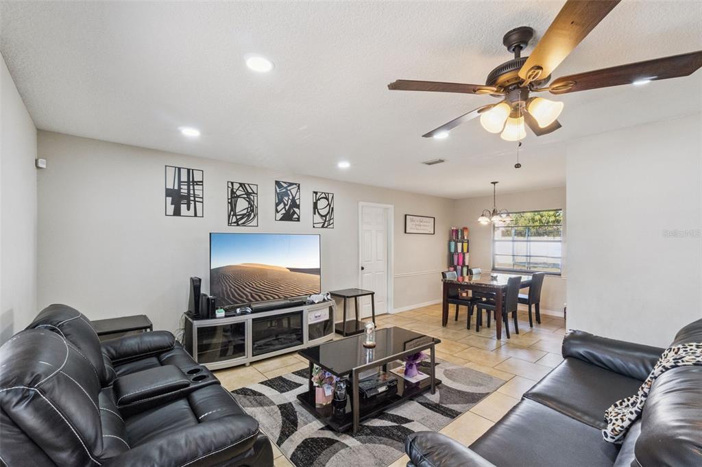 4608 Frisco Circle Orlando, FL 32808 - Photo 7 of 26 a living room with furniture a dining table and a window