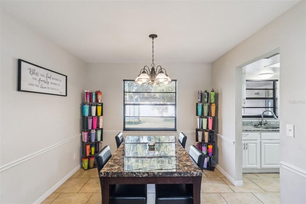 4608 Frisco Circle Orlando, FL 32808 - Photo 8 of 26 a living room with furniture and a chandelier