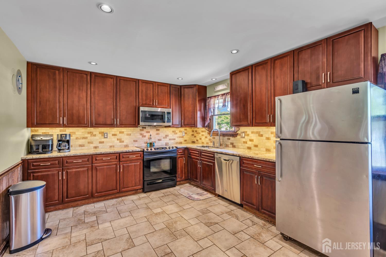 99 Schulmeister Road Old Bridge, NJ 08857 - Photo 5 of 49 a kitchen with stainless steel appliances granite countertop a refrigerator stove top oven and sink