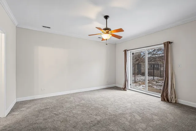 a view of a livingroom with a ceiling fan and window