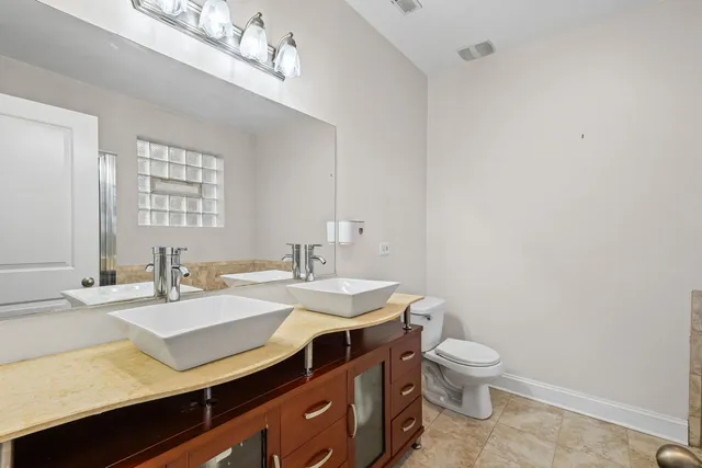 a bathroom with a sink a toilet and a mirror