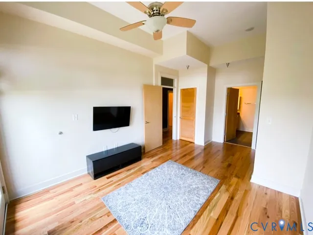 a living room with a flat screen tv and a rug