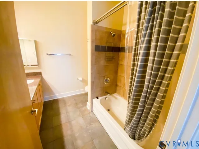 a bathroom with a bathtub and shower